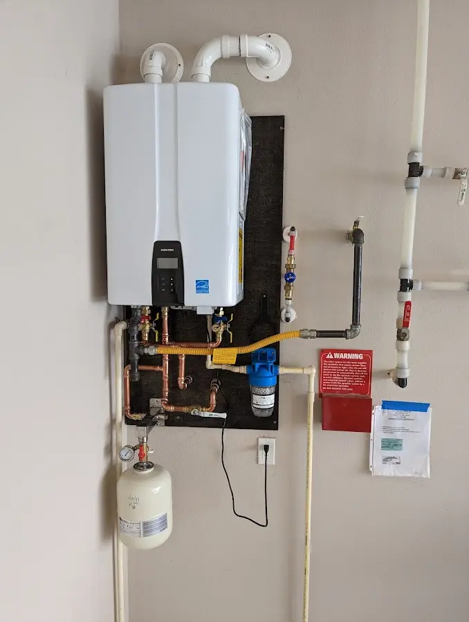 Professional plumber installing copper piping in a Norridge home